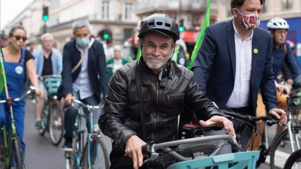 Carlos Moreno riding a bike in Paris, illustrating the 15-Minute City concept