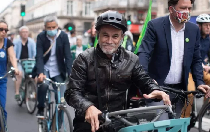 Carlos Moreno riding a bike in Paris, illustrating the 15-Minute City concept